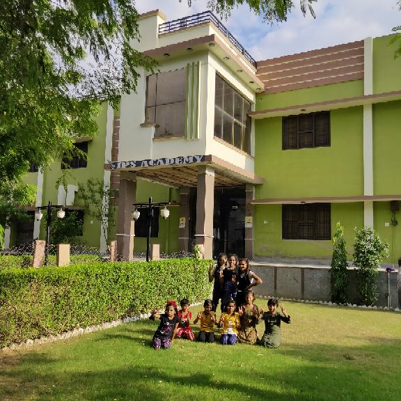 IPS Academy Ratangarh campus building and students in the garden